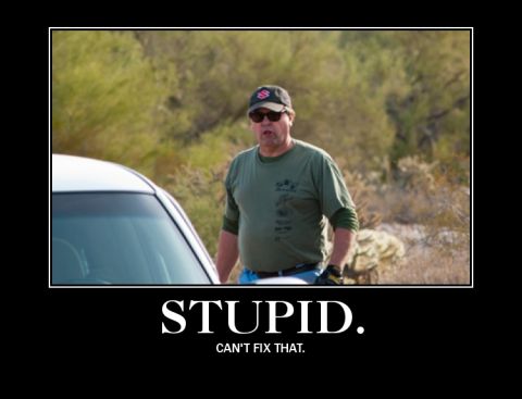 1987 Suzuki Samurai - A man stands next to a white car in a desert landscape, with the word "STUPID" overlaid.