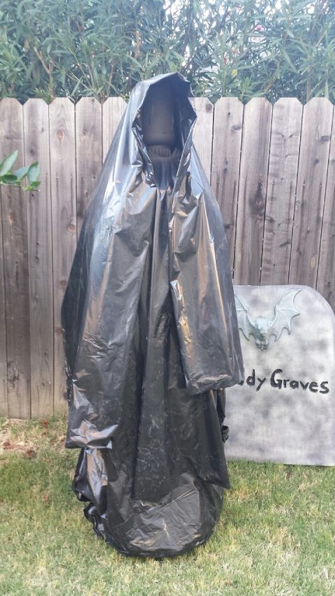 1989 Ford Bronco - Halloween decoration of a grim reaper figure with a tombstone prop in the background.