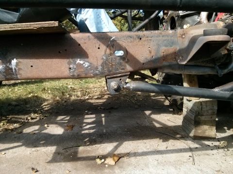 1986 Ford Bronco - Vehicle frame and suspension components are visible, supported by wooden blocks.