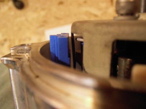 1990 Ford Bronco - Distributor cap with blue spark plug wires, likely from an older vehicle.