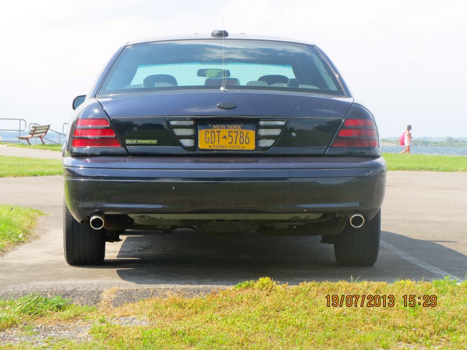 Rear view of a dark sedan with a New York license plate reading GDT-5786