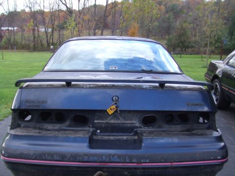 1996 Ford Bronco - The rear of a blue Ford Thunderbird is shown, missing its taillights and with a spoiler.