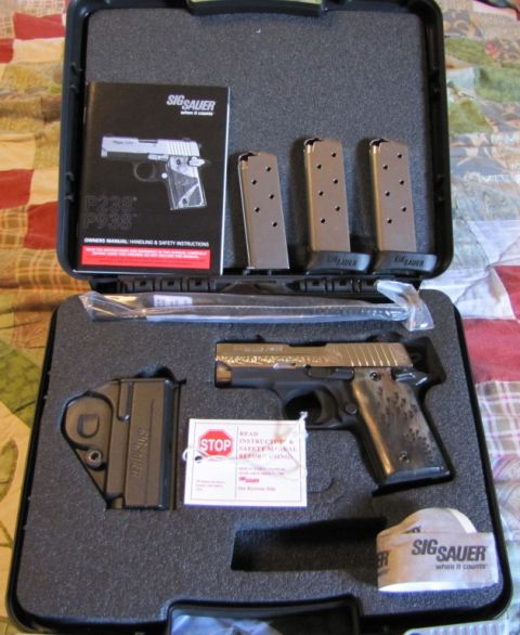 1992 Ford Bronco - This Sig Sauer pistol, model P238/P938, is presented in its case with accessories including magazines, a holster, and an owner's manual.