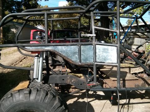 1986 Ford Bronco - A custom-built off-road buggy is shown with a red truck cab integrated into its structure.