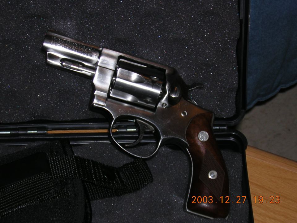 Revolver with wooden grips in a case