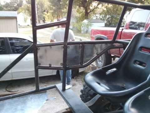 1986 Ford Bronco - Interior view of a custom off-road buggy, with a red pickup truck in the background.
