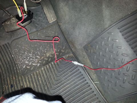 1996 Ford Bronco - Close-up of aftermarket wiring and a black box installed near the vehicle's pedals.