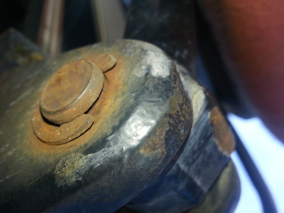 Close-up of rusted bolt and bracket assembly