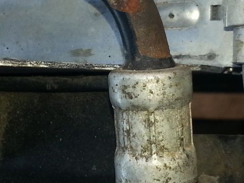 1994 Ford Bronco - Photograph of a metal pipe fitting on a vehicle, not a technical document.