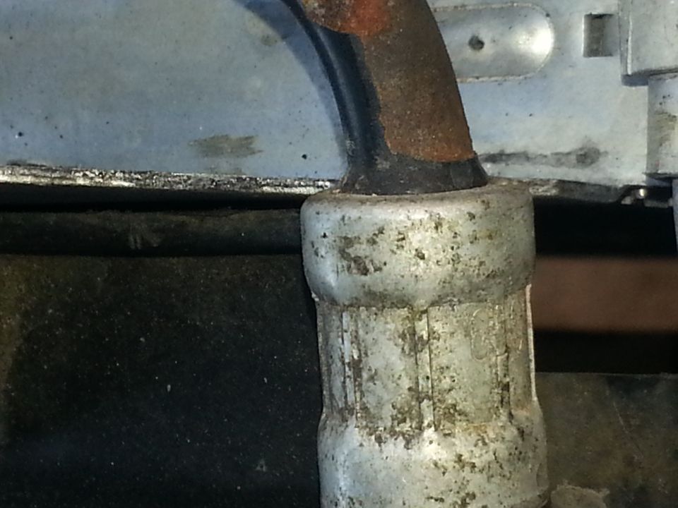 Close-up of a metal hose or pipe fitting on a vehicle component
