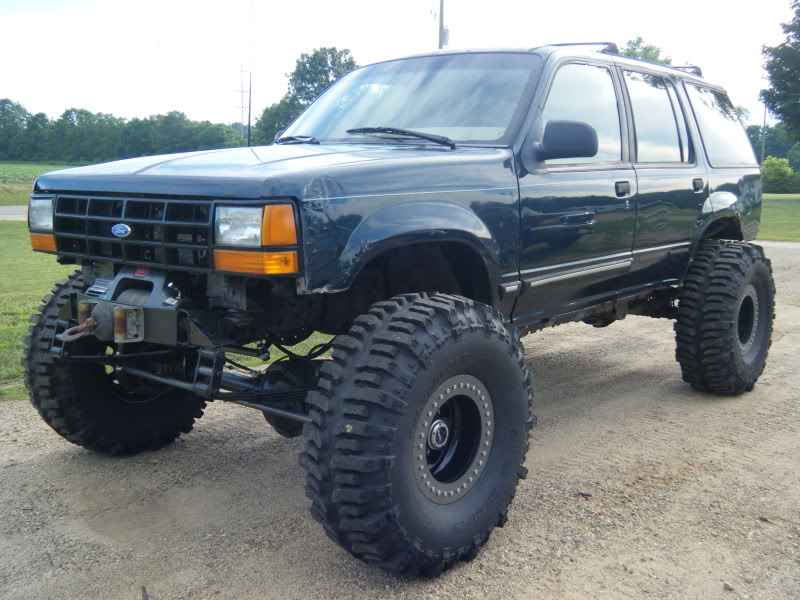Lifted 1993 Ford Explorer with large off-road tires and a front winch.