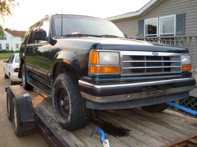 1993 Ford Explorer on a trailer, front 3/4 view.