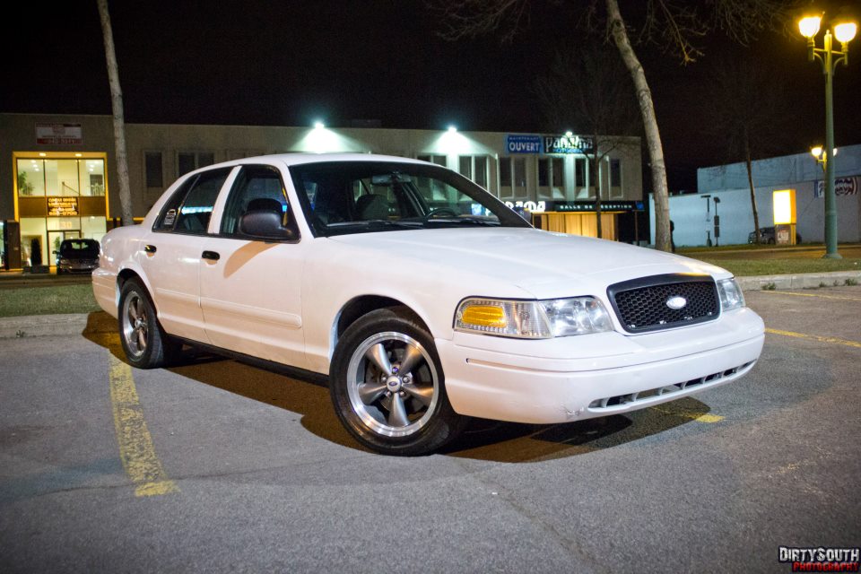 White 2006 Ford Crown Victoria parked at night.