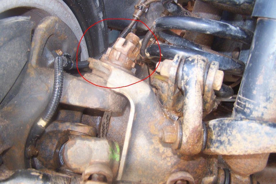 1995 Ford Bronco suspension and brake assembly with a sensor highlighted by a red circle.