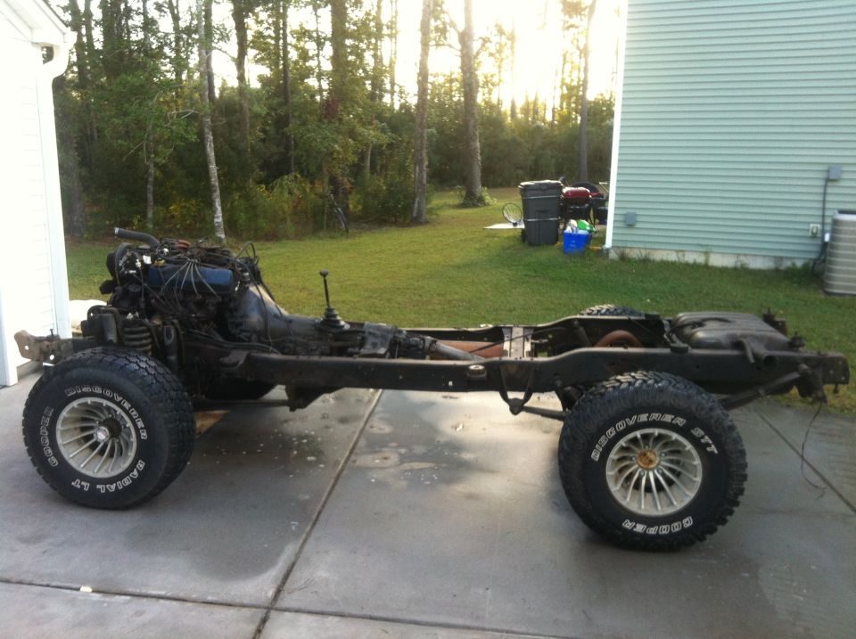 1979 Ford Bronco chassis with engine and transmission, side view.