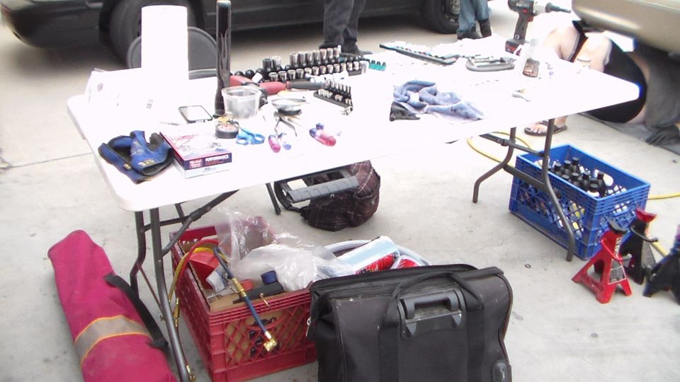 Folding table covered with tools and sockets at a garage