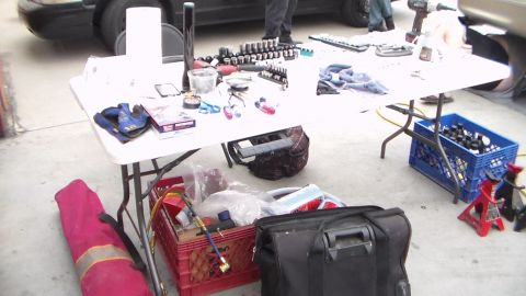 2003 Ford Crown Victoria - Photograph of automotive tools, sockets and jack stands spread on a folding table, not a technical document.