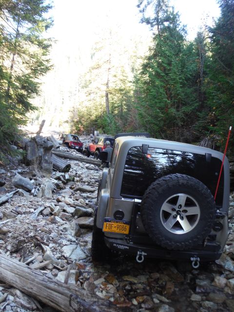 2005 Jeep Wrangler - Several Jeep Wranglers navigate a rocky, wooded trail.