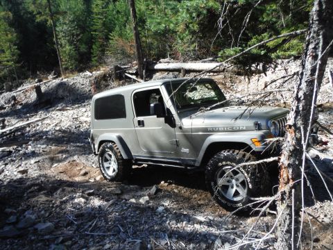 2005 Jeep Wrangler - This silver 2005 Jeep Wrangler Rubicon navigates a challenging rocky and wooded terrain.