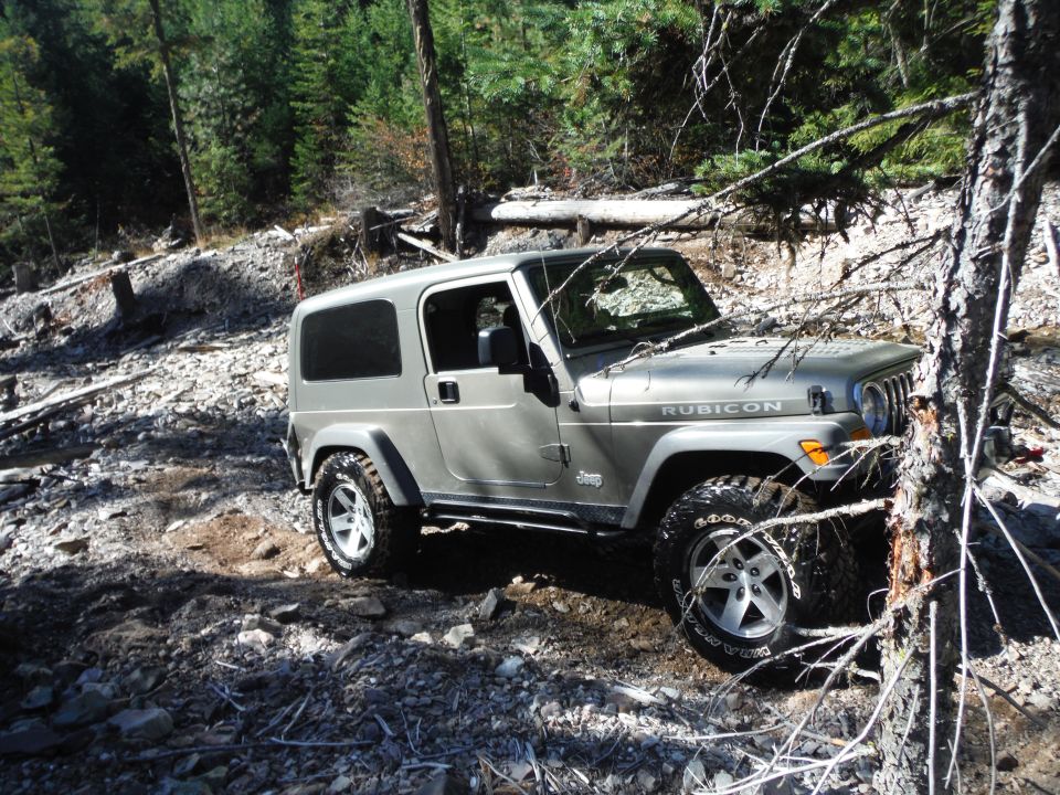 Silver 2005 Jeep Wrangler Rubicon on a rocky trail