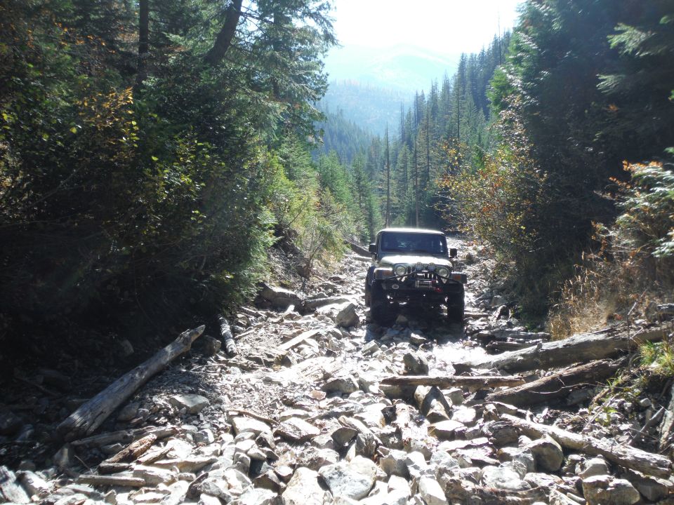 2005 Jeep Wrangler driving on a rocky mountain trail