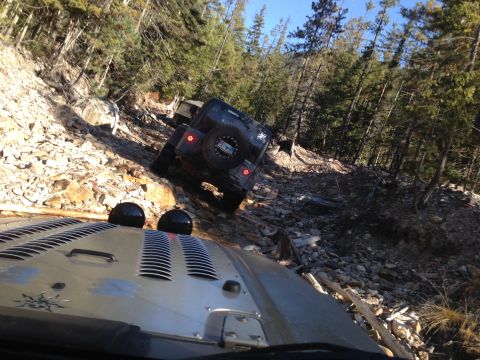 2005 Jeep Wrangler - Two Jeep Wranglers navigate a challenging off-road trail on a sunny day.