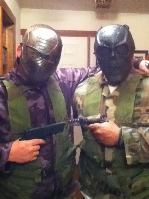 2006 Ford E350 - Two individuals are posing for a photo while wearing masks and tactical vests, each holding a toy firearm.