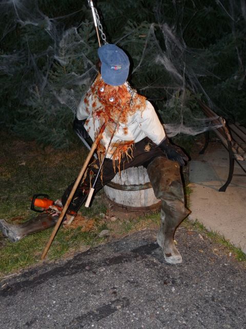 2006 Ford E350 - This Halloween decoration appears to be a figure made to look like a bloody victim, complete with fake eyes and a chainsaw.