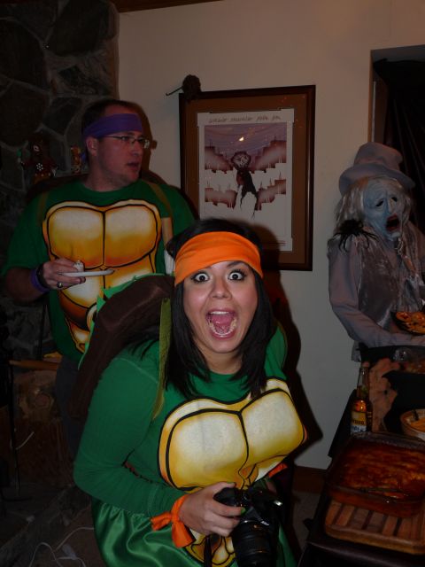 2006 Ford E350 - People dressed as Teenage Mutant Ninja Turtles pose for a photo at a party with a spooky decoration.