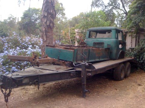 1968 Ford Mustang - A vintage green Jeep FC-170 cab sits on a flatbed trailer, appearing to be in a state of disrepair.