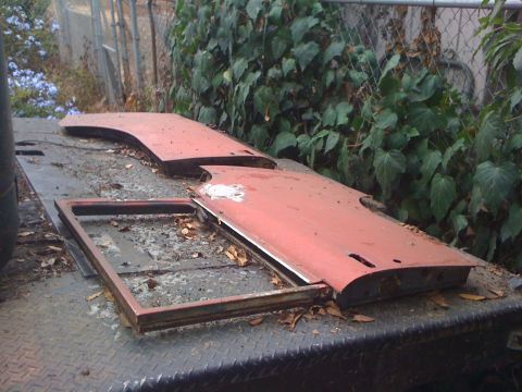 1968 Ford Mustang - Car doors and window frame on a trailer, covered in leaves and debris.