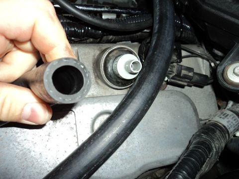 2004 Mercury Grand Marquis - Close-up of an engine component with a hose being held by a hand. The Supermotors.net logo is visible at the bottom right.