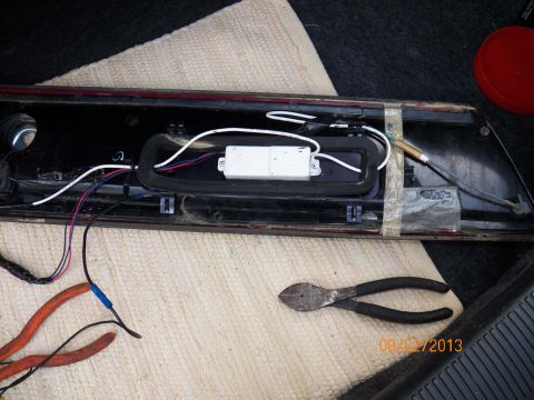 1998 Lincoln Mark VIII - A car's tail light assembly is shown with exposed wiring and a pair of pliers, dated 09/22/2013.