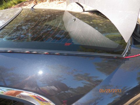 1998 Lincoln Mark VIII - Close-up of the rear window seal on a 1998 Lincoln Mark VIII.