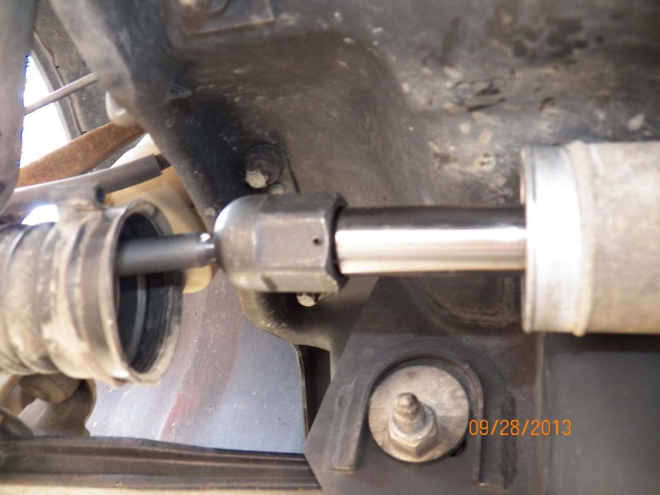Close-up of steering rack inner tie rod and boot under a 1998 Lincoln Mark VIII
