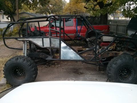 1986 Ford Bronco - Custom off-road buggy build in progress, with a red pickup truck visible behind it.