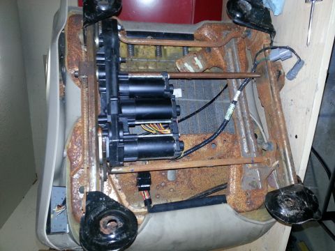 1994 Ford Bronco - Close-up view of a power seat mechanism, showing the motors and electrical components.