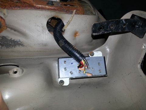 1994 Ford Bronco - Close-up view of an interior wiring harness and connector, showing exposed wires and a black protective conduit.