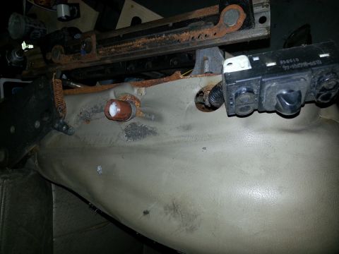 1994 Ford Bronco - Car seat mechanism and control module detail, showing wear and tear on the metal components.