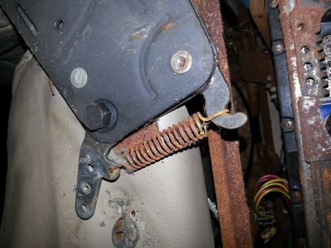 1994 Ford Bronco - The rusty spring and metal components of a vehicle seat mechanism are visible.