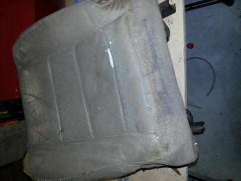 1994 Ford Bronco - This is a close-up view of a single, aged car seat, showing its texture and wear.
