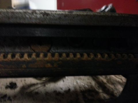 1994 Ford Bronco - A close-up view of a heavily rusted metal component with visible teeth, possibly from a mechanical assembly.