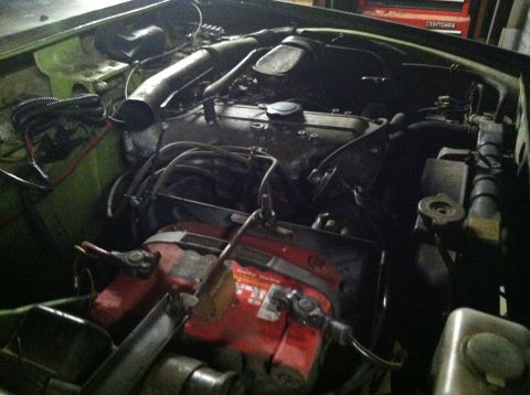 1975 Ford Courier - View of the engine bay, showing the battery and engine block.