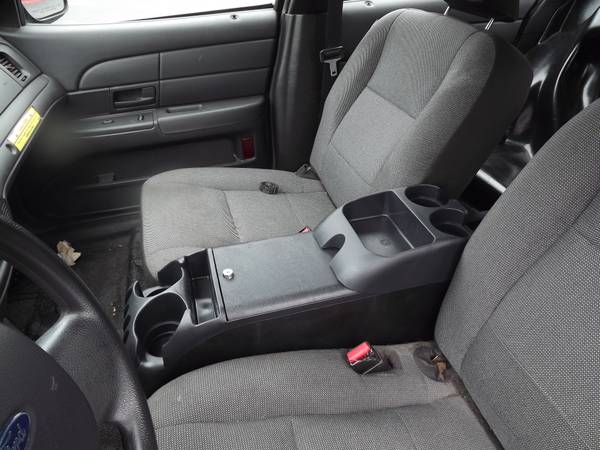 Interior of a Ford Crown Victoria showing front seats and center console.