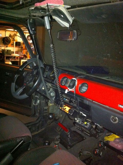 1987 Suzuki Samurai - The interior of a Suzuki Samurai with two CB radios mounted to the ceiling and a CB radio mounted to the dashboard. The vehicle has a red d…