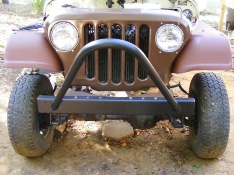 Brown Jeep CJ-5 front end with a black roll bar and aftermarket bumper