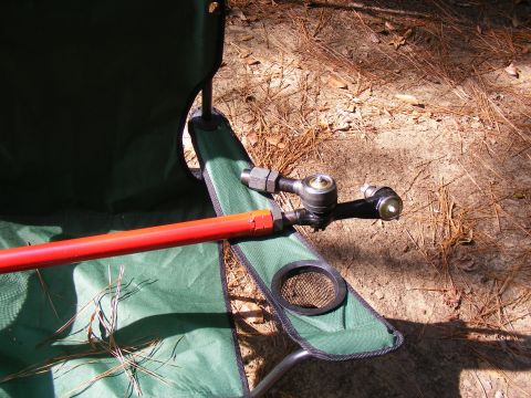 Red rod with tie rod ends resting on a green camping chair