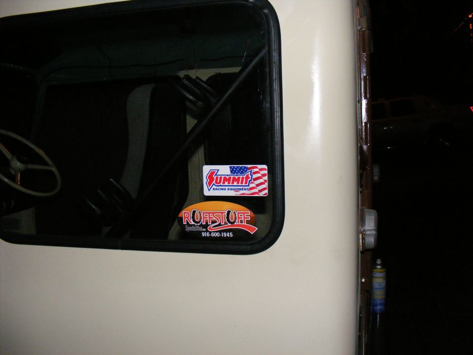 Cream 1978 Ford Bronco side view with Summit Racing and Ruffstuff stickers on the window