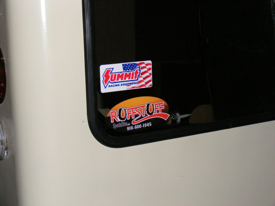 Vehicle window with Summit Racing Equipment and Ruffstuff Specialties stickers. Phone number 916-600-1945 visible