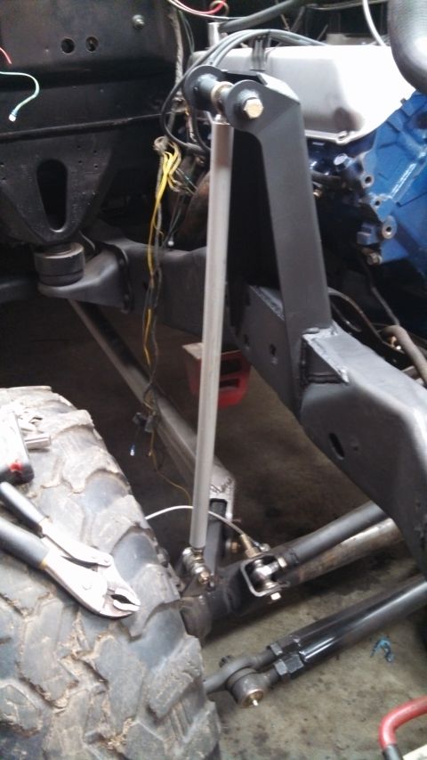 1967 Ford F-250 - Close-up view of a truck's suspension and engine bay, showing mechanical parts and wiring.